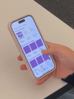Student holding a phone with the Canvas app open